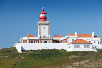 Fototapeta na wymiar Portugal. Cabo da Roca and the lighthouse over Atlantic Ocean, the most westerly point of the European mainland. Aerial view. Concept for travel in Portugal and most beautiful places in Portugal.