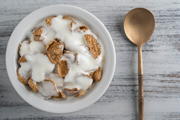 Whole grain glazed flakes with yogurt in plate. Healthy breakfast, whole grain muesli in a bowl