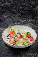 Beautiful serving of salad with salmon on a white plate on a dark textured background. Space for text. High quality photo