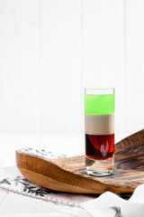 Colorful cocktail shots on a white background. Strong alcoholic drinks and tequila. High quality photo