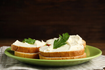 Bread with cream cheese and parsley on plate