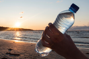 a bottle of water at sunset sun