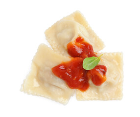 Tasty ravioli with tomato sauce on white background, top view