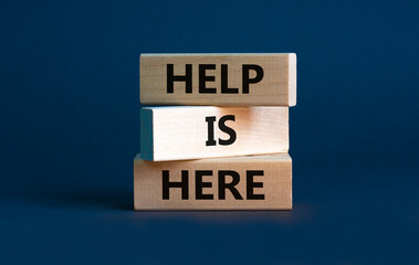 Help is here and support symbol. Wooden blocks with words 'Help is here' on beautiful grey...
