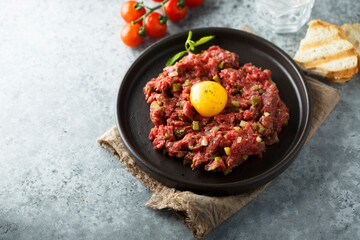 Traditional beef steak tartare with egg yolk