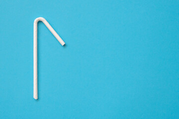 Biodegradable eco friendly white paper drinking straw on blue background