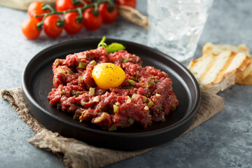 Traditional beef steak tartare with egg yolk