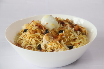 Home made chicken biriyani. Steamed basmati rice layered with yogurt based spicy gravy of boneless chicken, caramelized onions, ghee fried cashew nuts and raisins