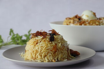 Home made chicken biriyani. Steamed basmati rice layered with yogurt based spicy gravy of boneless chicken, caramelized onions, ghee fried cashew nuts and raisins