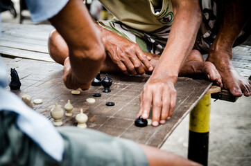 Closeup of men playingThai chess (Makruk)