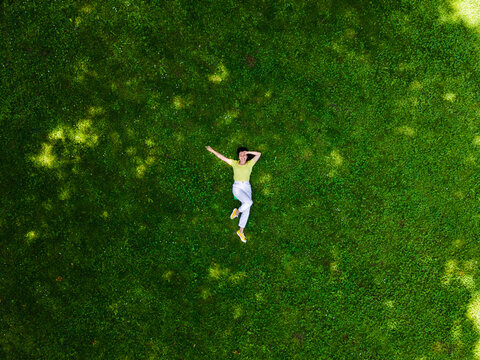 Portrait of woman touching grass Stock Photo - Alamy