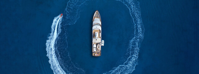 Aerial drone top down ultra wide panoramic photo of stunt man performing extreme stunts and...