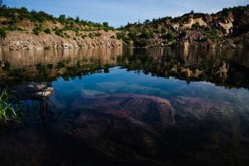 Fototapeta na wymiar Radon Lake with clear turquoise water is an abandoned granite quarry. Ukraine.