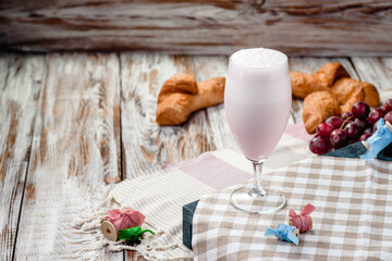 Strawberry pink milkshake in nice French composition. Space for text. High quality photo
