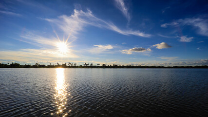 clear sky clouds sun rays over the river in daytime