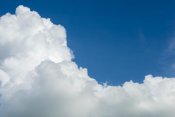 Naklejka na ściany i meble Cumulus white clouds floating on blue sky.