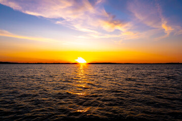 Sailing boat in the sea during awesome sunset. Luxury yacht and cruise holiday.