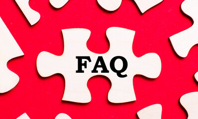 On a bright red background, white puzzles. In one of the pieces of the puzzle, the text FAQ