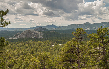 Black Hills, Keystone, SD, USA - May 31, 2008: Mount Rushmore lanscape scenery around under heavy rainy cloudscape. Mountains and green forest.