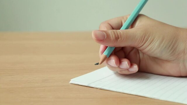 Woman writes pencil on paper  and broken pencil, Mistake or error concept, 