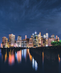 Fototapeta na wymiar downtown New York City at night beautiful reflections lights colors
