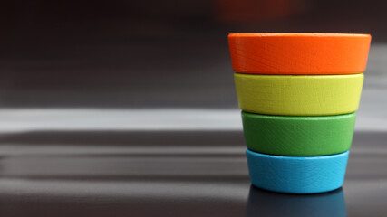 inverted multicolor child's pyramid on black background