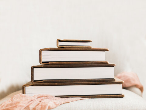 Stack Of 4 Photo Albums On Pink Linen