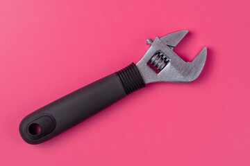 Adjustable wrench isolated on pink background