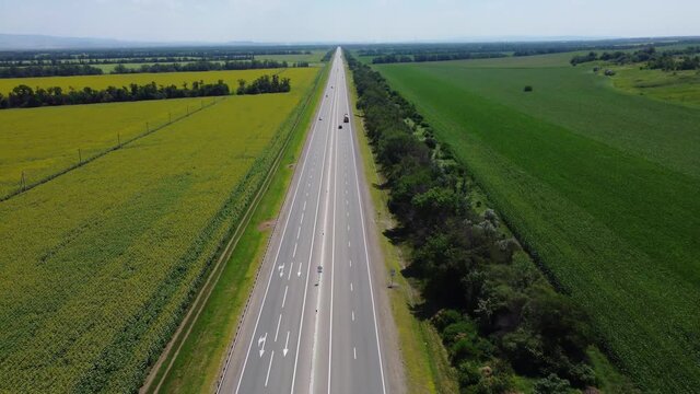 Country road. Track. Highway. View from a height. Fields and forests on the outskirts