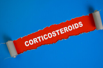 Corticosteroids Text written in torn paper