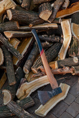 Ax lies on  pile of firewood