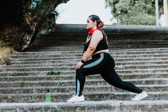 plus size young latin woman running in park in Mexico
