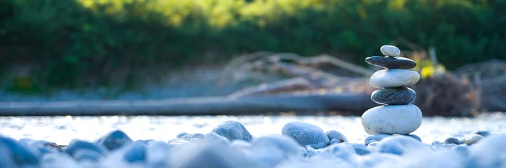 Fototapete Beruhigend stones stacked on the river bank. Concept: nature, mental balance, meditation, relax, pace, zen. banner  © Luca