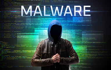 Faceless hacker on code background