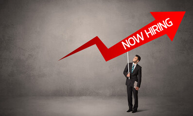 Obraz premium Young business person in casual holding road sign