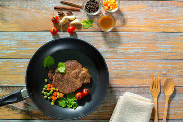 beef steak in pan,Grill beef juicy sirloin steaks with vegetable and moshrooms in grill pan.