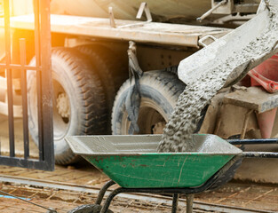Concrete mixer pours down concrete in construction site