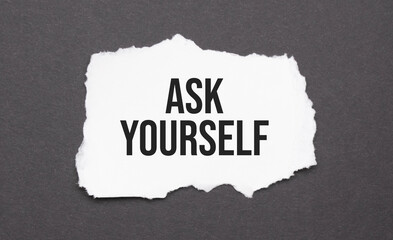Ask Yourself sign on the torn paper on the black background