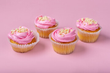 Cupcakes on a pink background. Cupcakes with yogurt and strawberry cream. Strawberry cupcakes.