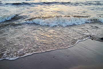 small surf waves on a sandy beach