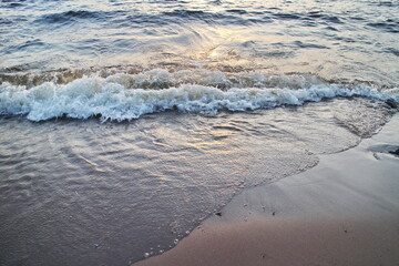 small surf waves on a sandy beach