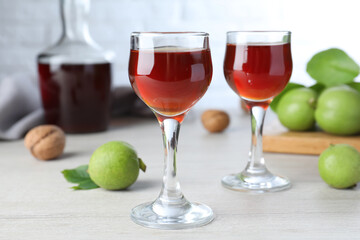 Delicious liqueur and fresh walnuts on wooden table
