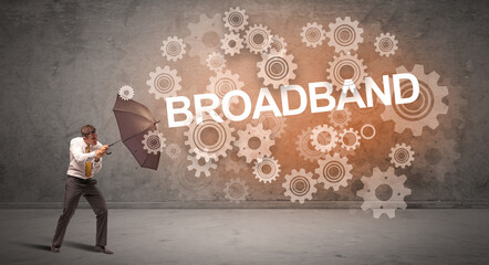 Businessman defending with umbrella concept