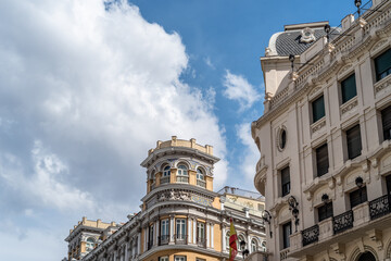 Fototapeta na wymiar Historic residential buildings in Gran Via, the iconic avenue of Madrid famous for his cinemas and stores