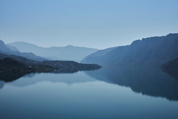 blue mountains are reflected in the water