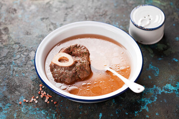 Homemade organic bone Broth soup with Meat and spice in a white bowl, selective focus