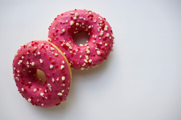 sweet dessert. round donuts with pink icing isolated on white background and raspberries 