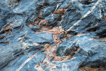 Blue grey orange rock structure, background texture