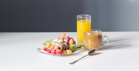 coffee, juice and berries dessert on white table