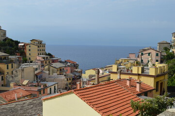 Naklejka premium The cityscape of medieval fishing Riomaggiore (Cinque Terre)lost in the mountains and surrounded by Mediterranean sea.